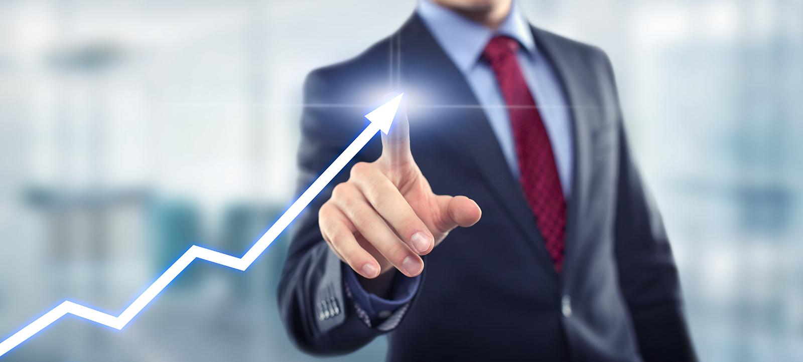 Man with graph indicating growth 